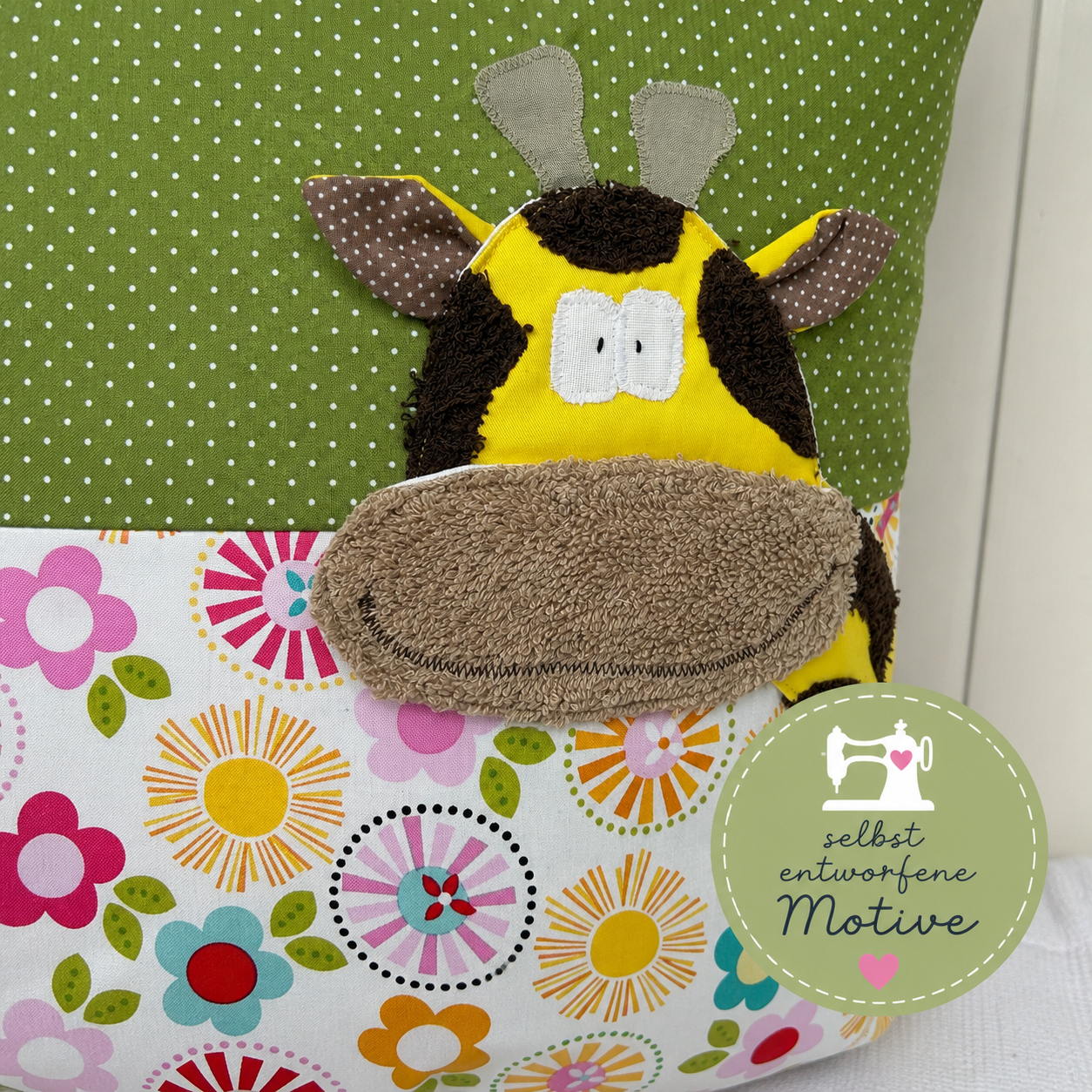 Kissen Giraffe in grün gepunktet und großen bunten Blumen und leuchtend gelber Giraffenapplikation, selbst entworfene Motive von karingelchen